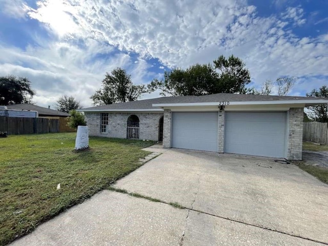 single story home with a garage and a front yard