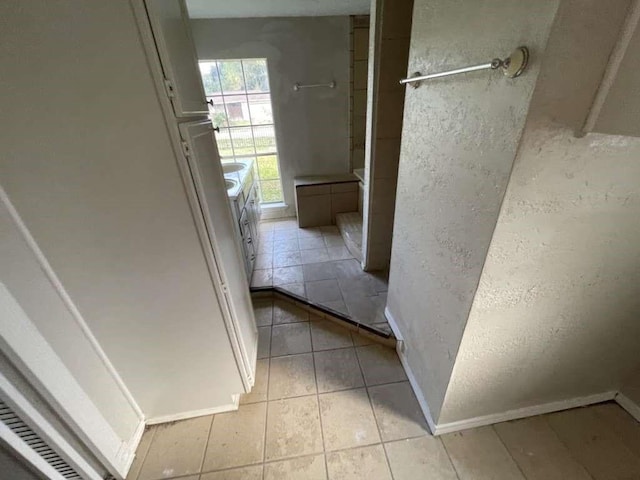 hallway featuring light tile patterned flooring