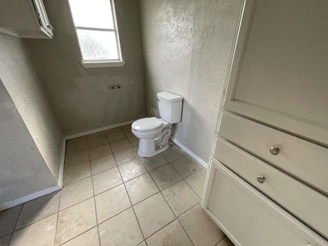 bathroom featuring tile patterned floors and toilet