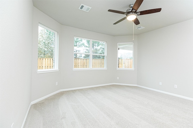 carpeted spare room with ceiling fan