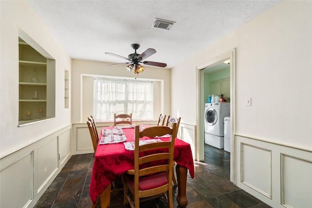 dining space with ceiling fan, washer and dryer, and a textured ceiling