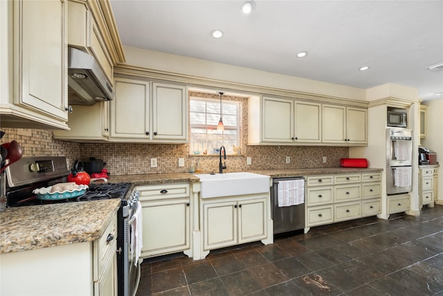 kitchen with extractor fan, sink, light stone countertops, stainless steel appliances, and cream cabinets