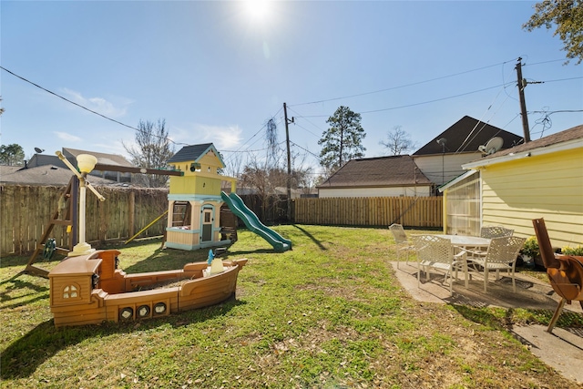 view of yard featuring a playground and a patio