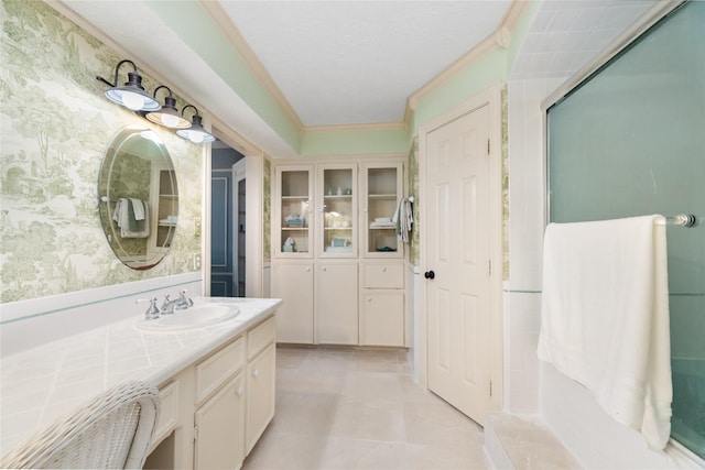 bathroom featuring a shower with door, vanity, tile patterned floors, and crown molding