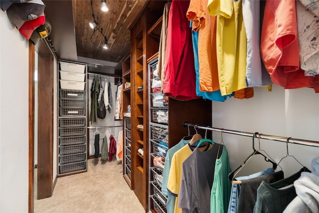 walk in closet featuring light carpet