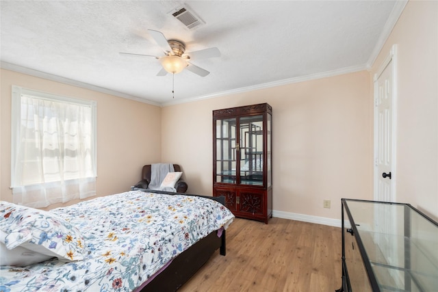 bedroom with ornamental molding, light hardwood / wood-style floors, and ceiling fan