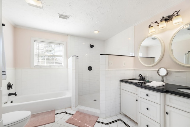 full bathroom featuring vanity, plus walk in shower, a textured ceiling, tile patterned floors, and toilet