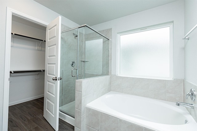 bathroom featuring separate shower and tub and hardwood / wood-style floors