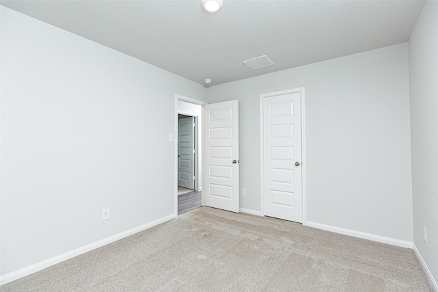 unfurnished bedroom with light carpet