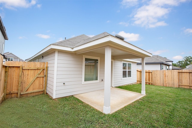 back of house with a yard and a patio area