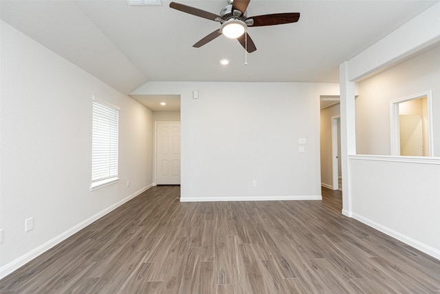 spare room with lofted ceiling, dark hardwood / wood-style floors, and ceiling fan