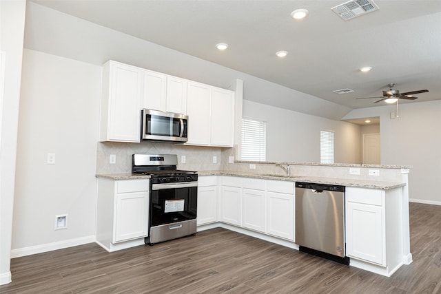 kitchen featuring white cabinetry, stainless steel appliances, and kitchen peninsula