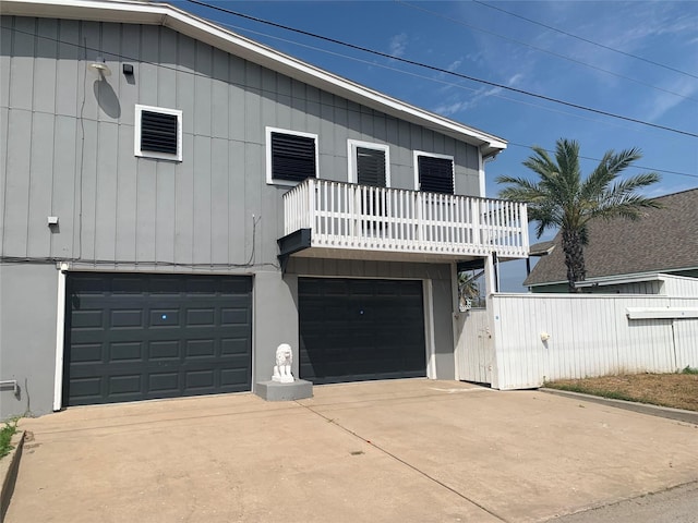 view of front facade with a garage and a balcony