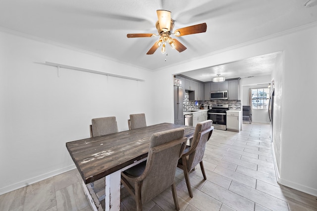 dining area with ornamental molding and ceiling fan