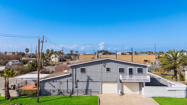 view of front of home featuring a garage, a balcony, and a front yard