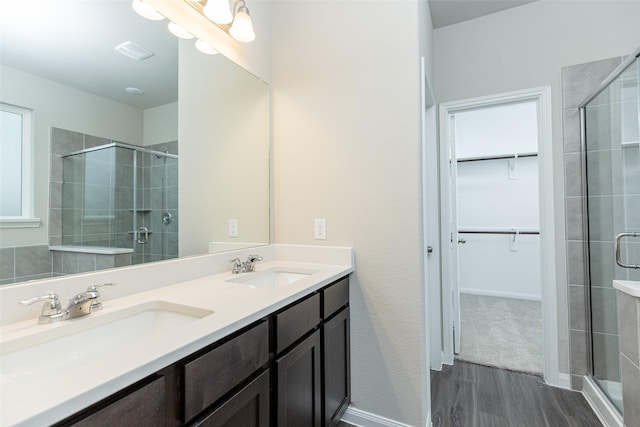 bathroom with vanity, hardwood / wood-style flooring, and a shower with door