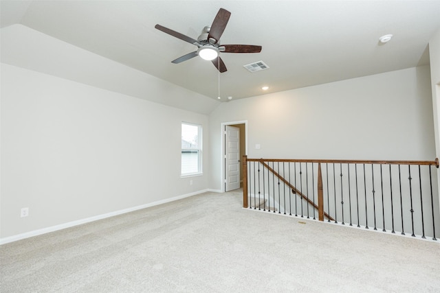 carpeted empty room with lofted ceiling and ceiling fan