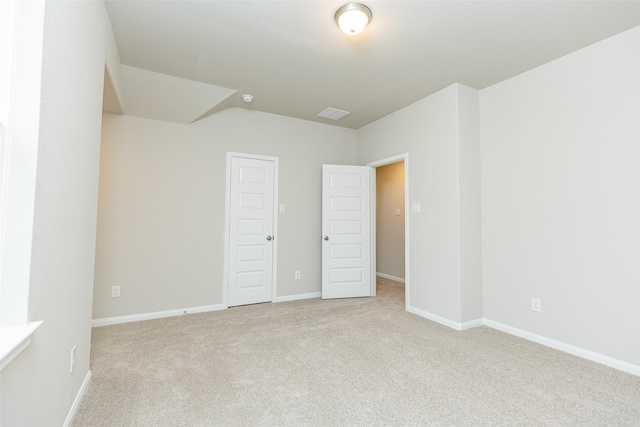 unfurnished bedroom featuring light carpet