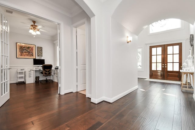 entryway with crown molding, dark wood-type flooring, ceiling fan, and french doors