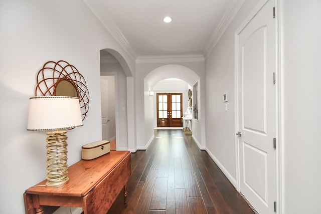 hall with ornamental molding, dark hardwood / wood-style flooring, and french doors