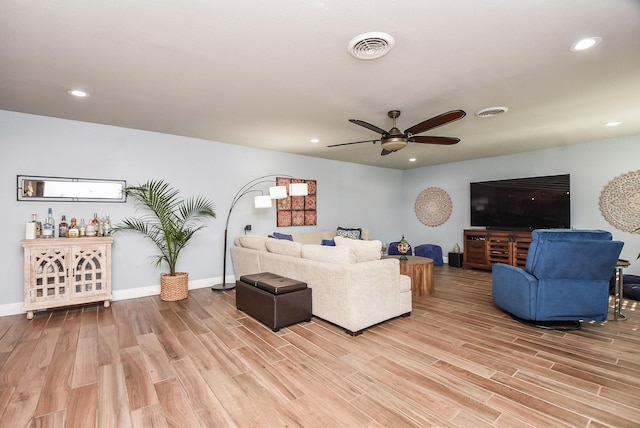 living room featuring wood-type flooring and ceiling fan