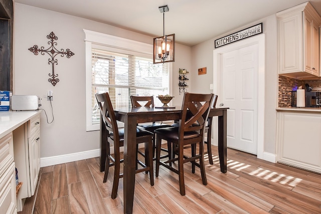 dining area with an inviting chandelier and light wood-type flooring