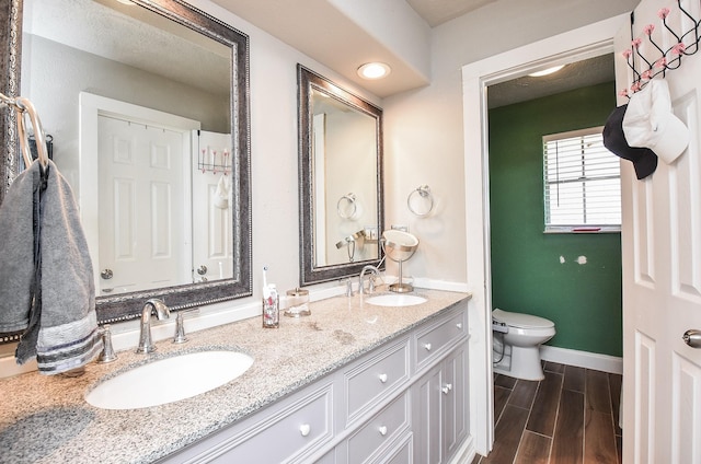 bathroom featuring vanity and toilet