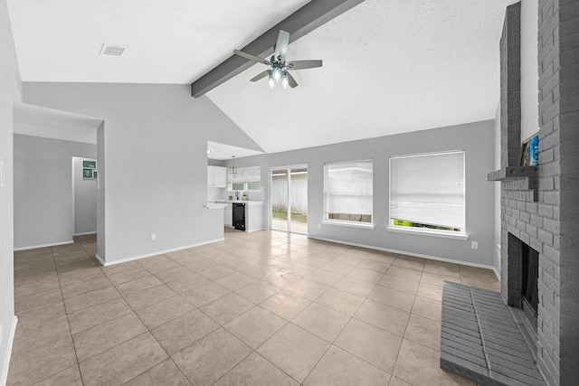 unfurnished living room featuring ceiling fan, vaulted ceiling with beams, a wealth of natural light, and a fireplace