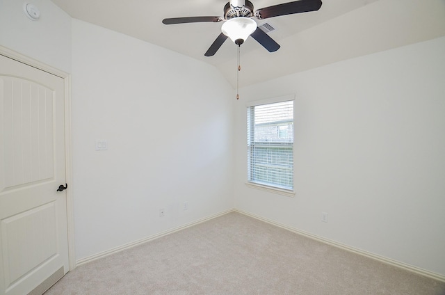 spare room with lofted ceiling and light colored carpet