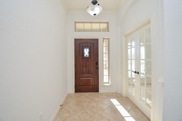 tiled foyer entrance featuring ornamental molding and french doors