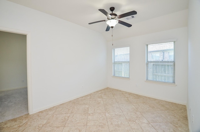 tiled spare room featuring ceiling fan