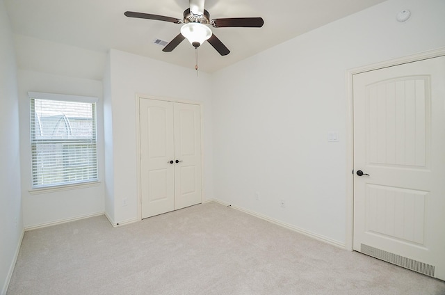 unfurnished bedroom with ceiling fan and light carpet