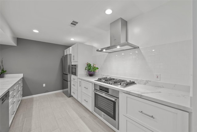 kitchen with white cabinets, stainless steel appliances, and island range hood