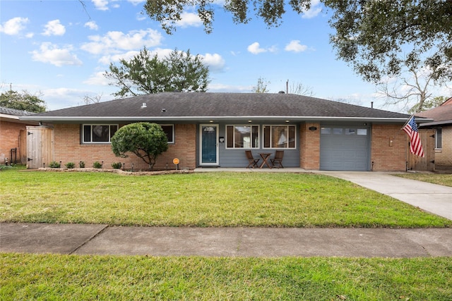 ranch-style home with a garage and a front lawn