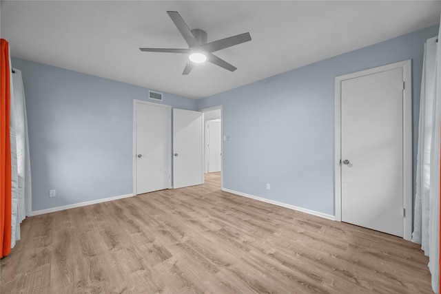 unfurnished bedroom with ceiling fan and light hardwood / wood-style flooring