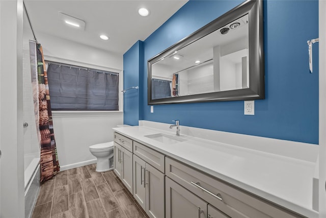 full bathroom with vanity, shower / tub combo, and toilet