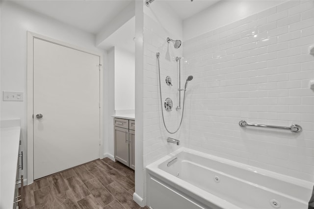 bathroom featuring vanity and tiled shower / bath