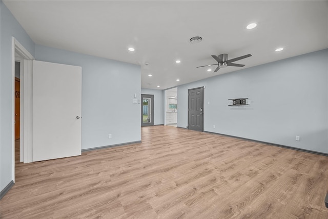 unfurnished living room with ceiling fan and light wood-type flooring