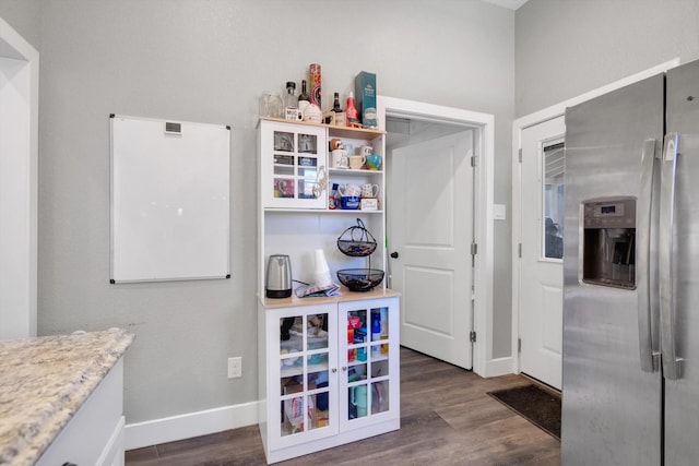 kitchen featuring dark wood-type flooring and stainless steel fridge with ice dispenser