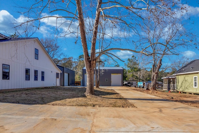 view of side of property with a garage and an outdoor structure