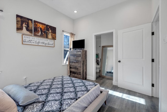 bedroom with wood-type flooring and connected bathroom