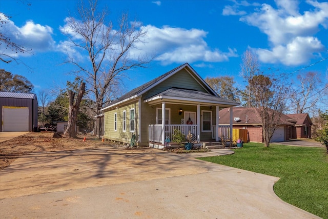 bungalow-style home with a porch, a garage, and a front yard