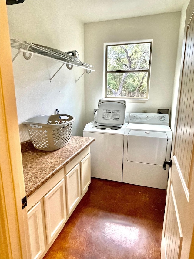 laundry room featuring cabinets and washing machine and dryer