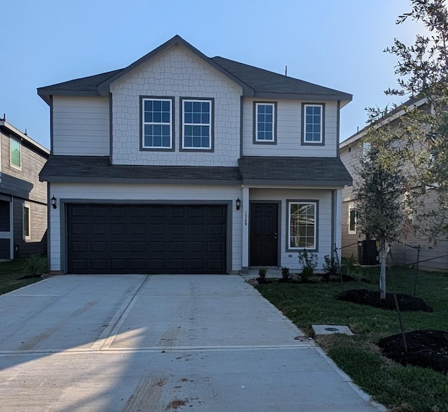 view of front property with a garage, central AC, and a front yard