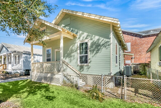 exterior space with central AC, a front yard, and a porch