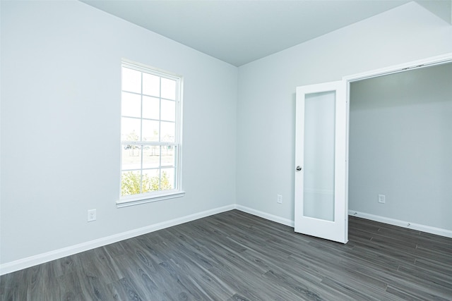 unfurnished room featuring dark hardwood / wood-style flooring