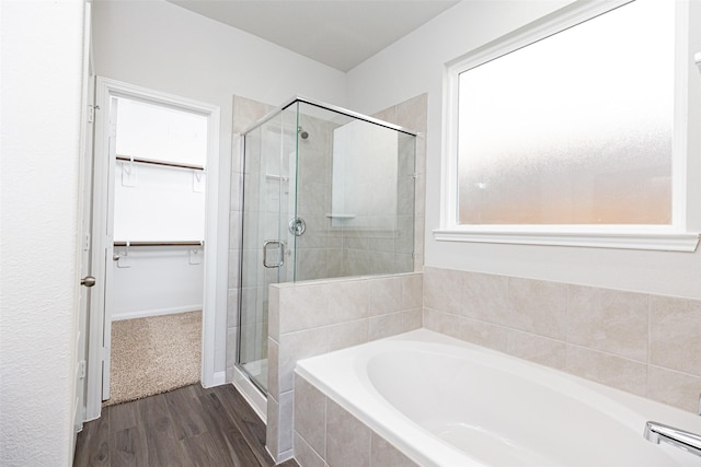 bathroom featuring hardwood / wood-style flooring and shower with separate bathtub