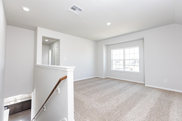 spare room with lofted ceiling and carpet floors