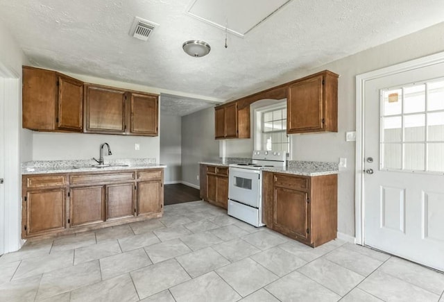 kitchen with sink, a textured ceiling, and white range with electric stovetop