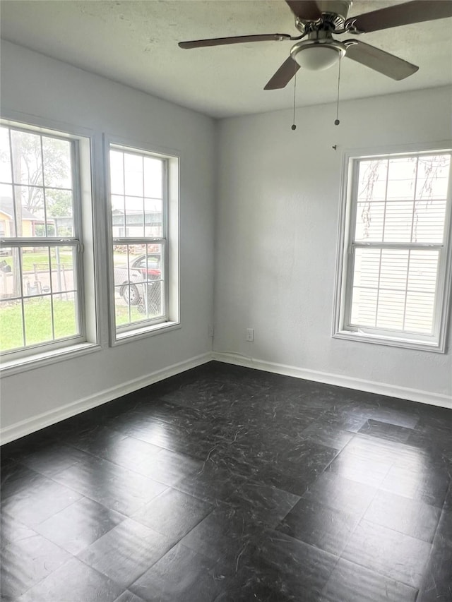 unfurnished room with ceiling fan